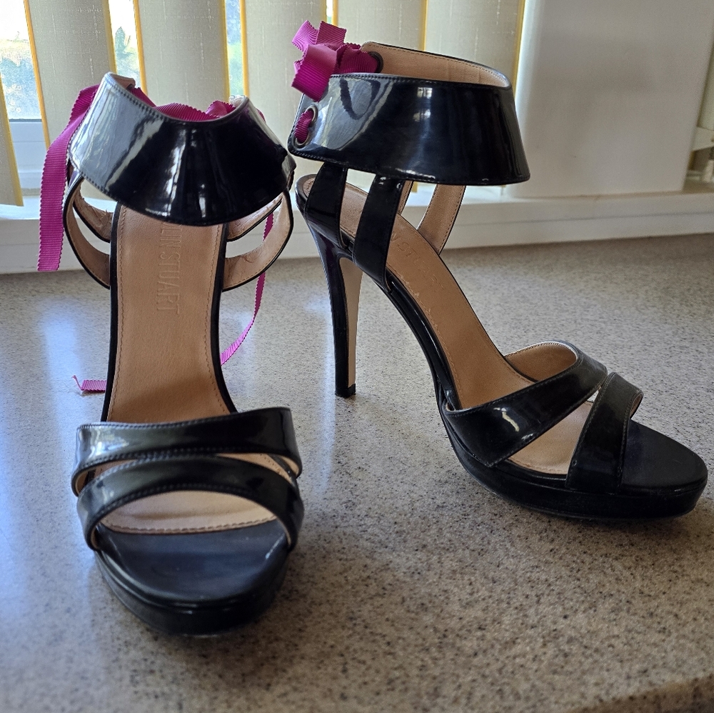 Colin Stuart 4 in patent leather heels.
